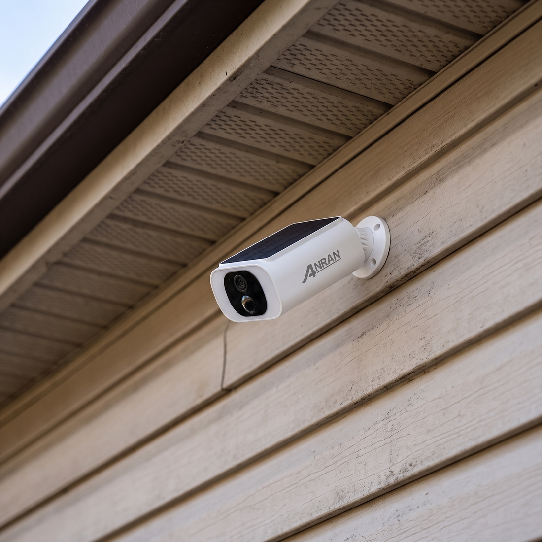 Solar security camera mounted under the eaves of a house