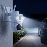 Camera at night with its white spotlights lighting the driveway