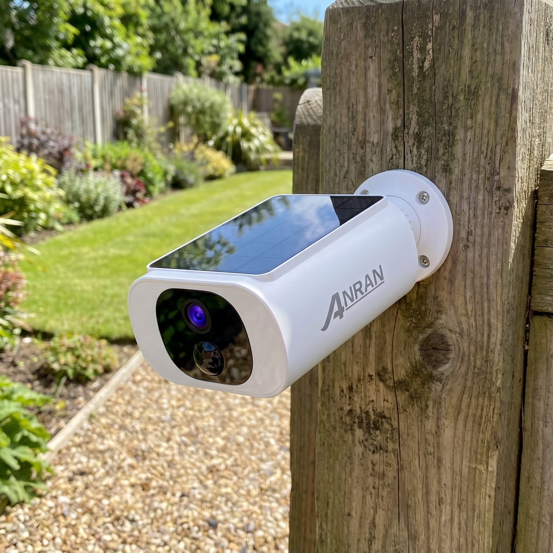 The camera bolted to a timber gate post in full sun, with no cable behind it