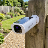 The camera bolted to a timber gate post in full sun, with no cable behind it