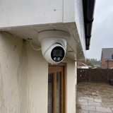 Rain beading on the dome camera under a wet soffit