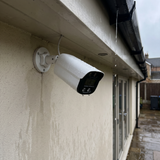 Rain running off the bullet camera under a wet soffit